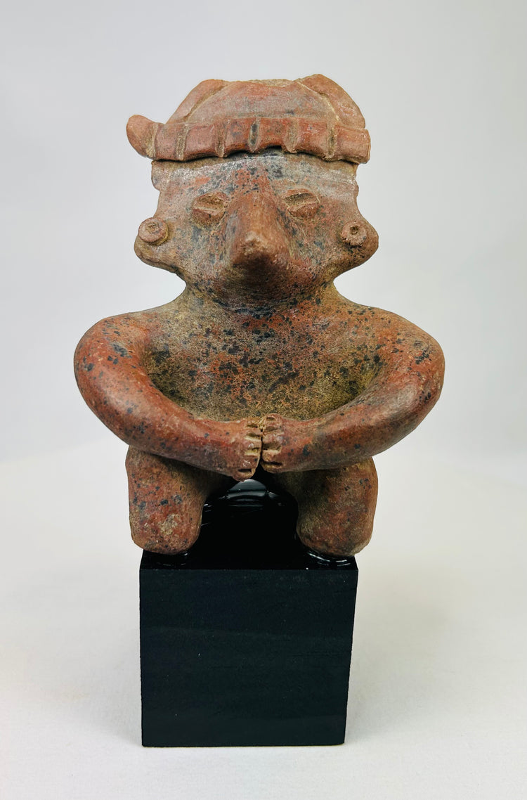 Pre-Columbian Nayarit terracotta seated figure with headdress on black display base.