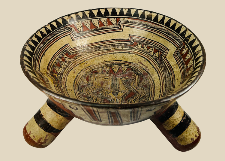 Front view of Pre-Columbian Nicoya rattle tripod bowl showing painted geometric motifs and tripod form.