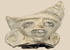 Pre-Columbian terracotta figural fragment depicting a stylized human face with large earspools and fan-shaped headdress, Mesoamerica, circa 600–1200 CE.