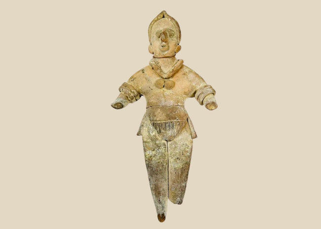 Ancient Pre-Columbian terracotta figurine, circa 300–900 CE, depicting a stylized human figure with detailed jewelry and headdress, shown standing with arms extended.