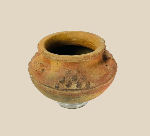 Pre-Columbian terracotta vessel from Central or South America, 800–1500 CE, featuring raised decorative clusters and sculpted motifs. Hand-molded clay vessel reflects Mesoamerican or Andean ritual and ceremonial craftsmanship, highlighting fertility and spiritual symbolism in ancient civilizations.