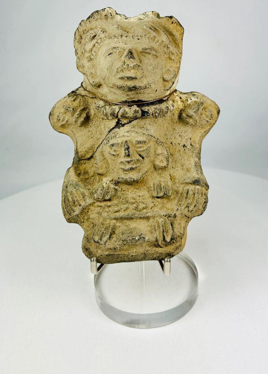 Ancient Pre-Columbian Veracruz ceramic effigy depicting two joined human figures, hand-modeled with stylized facial features and incised details, tan clay with surface wear and encrustation, dating to circa 300 BCE–600 CE, representing Mesoamerican ritual and symbolic artistry.