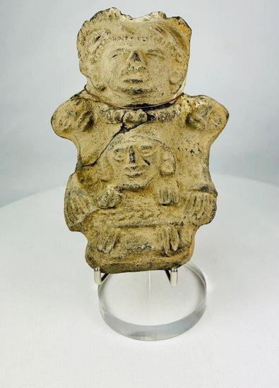 Ancient Pre-Columbian Veracruz ceramic effigy depicting two joined human figures, hand-modeled with stylized facial features and incised details, tan clay with surface wear and encrustation, dating to circa 300 BCE–600 CE, representing Mesoamerican ritual and symbolic artistry.