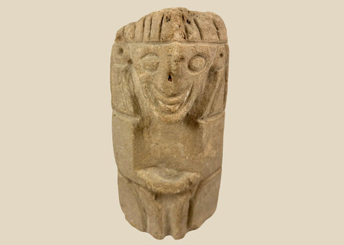 Pre-Columbian carved stone idol from West Mexico or Andean Highlands, circa 500–1000 CE, hand-carved volcanic stone or sandstone, stylized anthropomorphic features with almond-shaped eyes and geometric body, compact ritual or domestic shrine figure