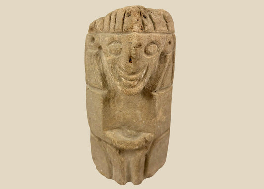 Pre-Columbian carved stone idol from West Mexico or Andean Highlands, circa 500–1000 CE, hand-carved volcanic stone or sandstone, stylized anthropomorphic features with almond-shaped eyes and geometric body, compact ritual or domestic shrine figure