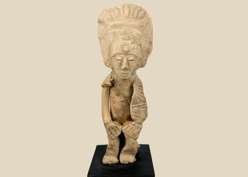 Pre-Columbian West Mexican terracotta standing figure, 300 BCE–500 CE, Nayarit or Jalisco shaft tomb culture, with tall radiating headdress, abstract geometric features, and mineral accretions, mounted on display base