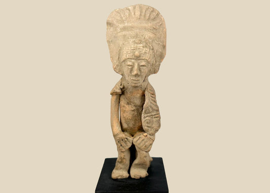 Pre-Columbian West Mexican terracotta standing figure, 300 BCE–500 CE, Nayarit or Jalisco shaft tomb culture, with tall radiating headdress, abstract geometric features, and mineral accretions, mounted on display base