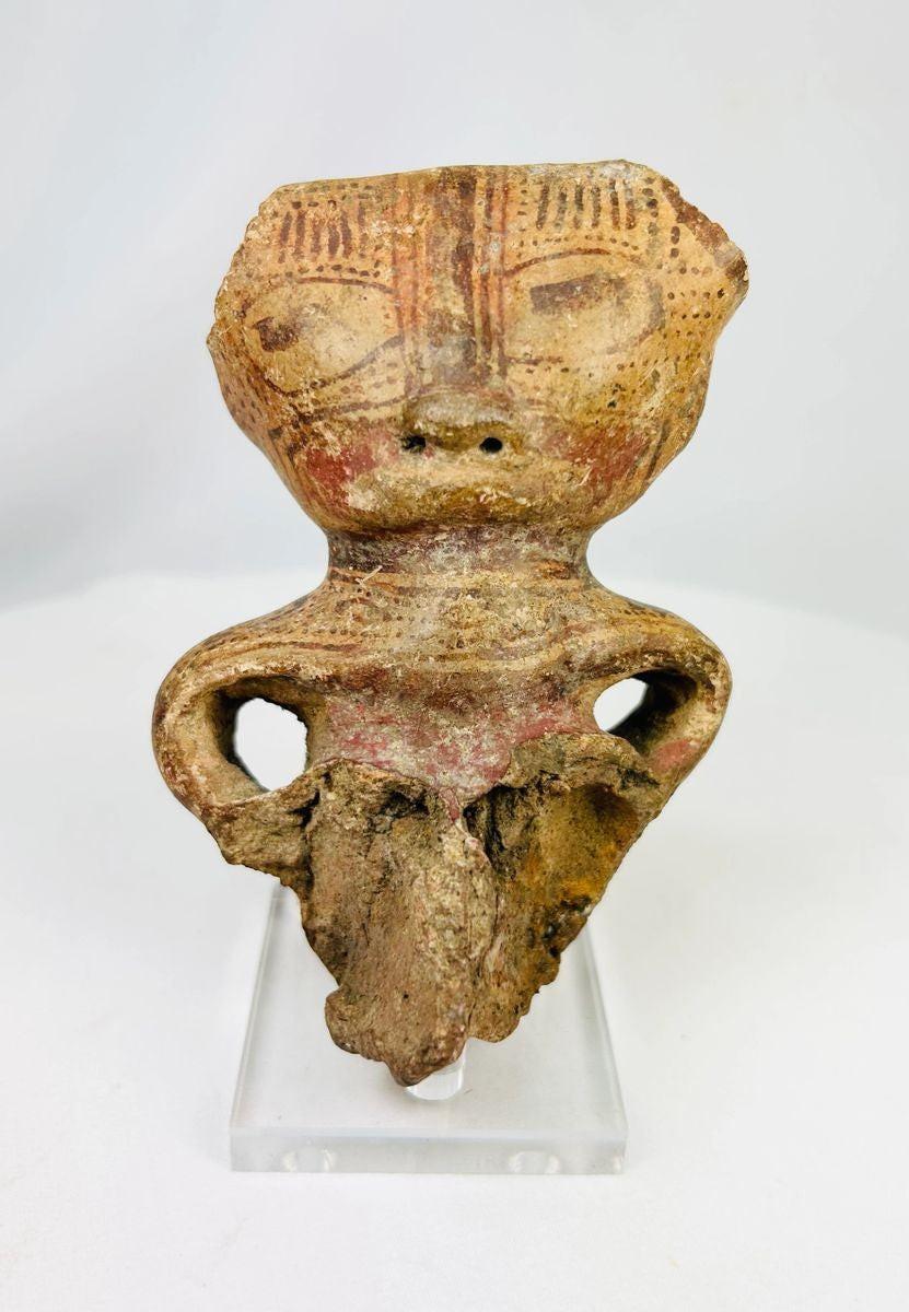 Ancient Pre-Columbian West Mexican terracotta figurine fragment, dating circa 300 BCE–300 CE, depicting a stylized human figure with incised facial features, hollow body form, and traces of red pigment; culturally significant artifact from early shaft tomb traditions, showing archaeological wear and breakage consistent with great age.