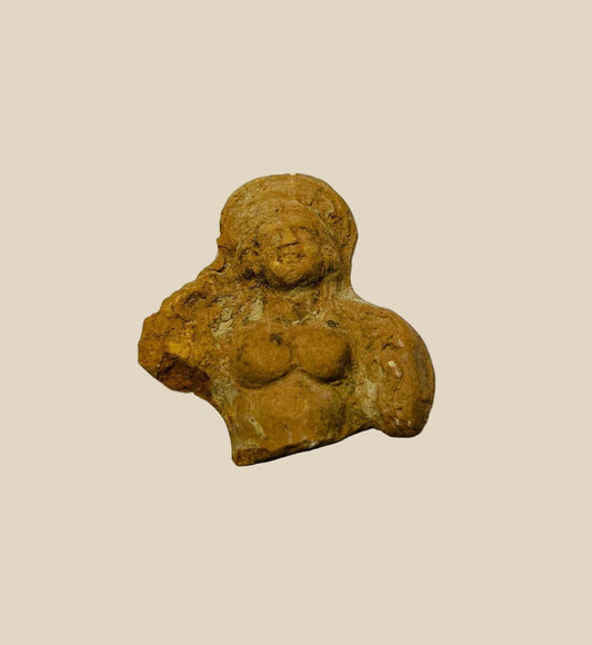 Terracotta fragment depicting partial female figure with upper torso and facial features, Ptolemaic Egypt, circa 200–100 BCE, showing Hellenistic-Egyptian artistic fusion and ancient patina.