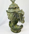 Side view of an 18th-century Qing bronze incense burner showing detailed elephant-head handle and phoenix relief.