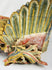 Close-up of gilded phoenix wing from Qing Dynasty camphor wood relief, showing layered carving, polychrome pigments, and ornate scrollwork base – Relic and Rarity.