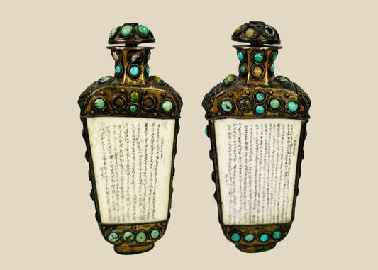 Ornate bronze ritual flask from the Sino-Tibetan border region, decorated with cabochon turquoise and green stones, carved bone panels with Tibetan or Sanskrit inscriptions, and guardian lion masks in relief, 5 inches tall by 2.5 inches wide, late Qing Dynasty, circa late 19th century.