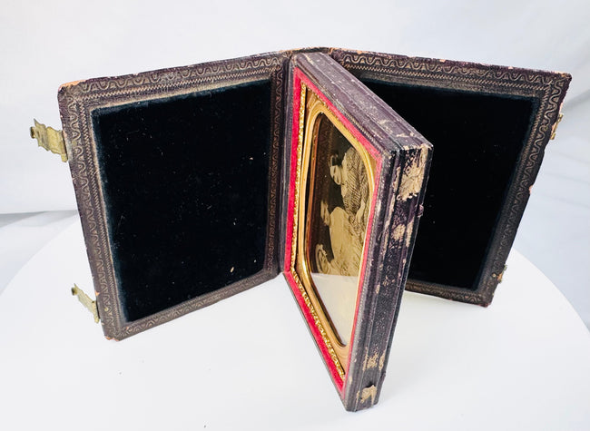 Victorian cased ambrotype with women wearing gingham dresses and an elaborate bonnet