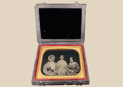 Quarter-plate Victorian ambrotype depicting three female sitters in period dress