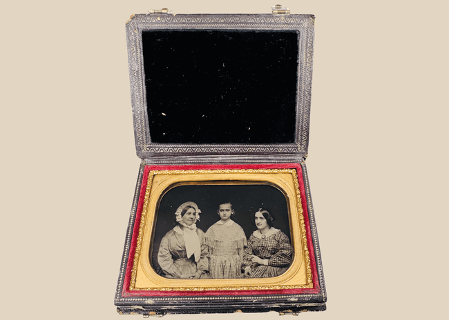 Quarter-plate Victorian ambrotype depicting three female sitters in period dress