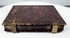 Cased Victorian ambrotype featuring detailed clothing, bonnet ribbons, and period jewelry