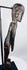 Side view of elongated moai kavakava-inspired wooden sculpture on black display stand