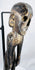 Close-up of Rapa Nui-style wooden figure showing recessed eyes, nose and carved teeth