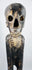 Rapa Nui-inspired hardwood sculpture with skull-like face and prominently carved ribs