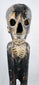 Rapa Nui-inspired hardwood sculpture with skull-like face and prominently carved ribs