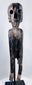 Front view of carved Polynesian-style moai kavakava figure with hollow eyes and rib cage
