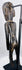 Rear view of hand-carved Rapa Nui-inspired moai kavakava figure and aged hardwood surface