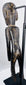 Rear view of hand-carved Rapa Nui-inspired moai kavakava figure and aged hardwood surface