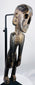 Three-quarter view of hand-carved Rapa Nui-inspired figure with dark aged surface