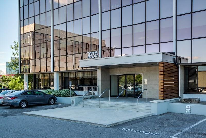 Front view of the Relic & Rarity location at 7030 Woodbine Avenue in Markham, featuring the modern glass building exterior.