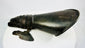 Close-up of 19th-century armour gauntlet reproduction displayed on white studio backdrop.