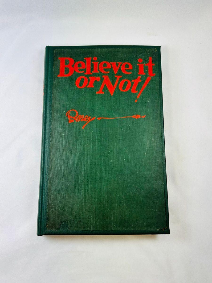 1929 first edition, 9th printing of Ripley’s Believe It or Not! hardcover book, signed by Robert Ripley with personal inscription to A. Nathan, featuring green cloth cover and red lettering.