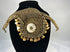 Melanesian ritual adornment featuring cowrie shell and pierced animal teeth