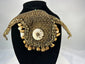 Melanesian ritual adornment featuring cowrie shell and pierced animal teeth