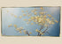 Original oil painting on canvas by Roland Patros, depicting a blossoming tree with delicate white and yellow flowers on twisting branches against a soft gradient blue background, mid–late 20th century.