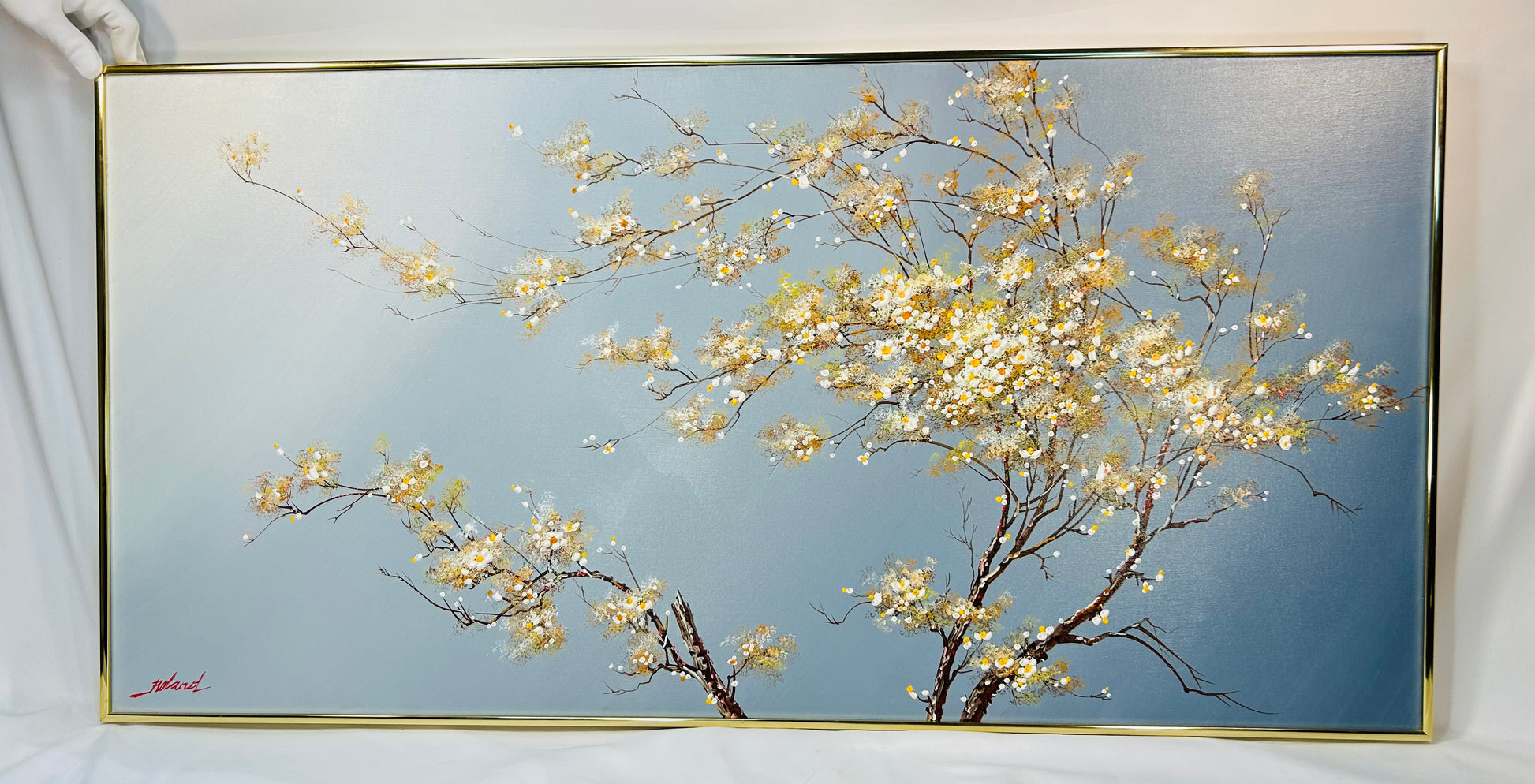 Original oil painting on canvas by Roland Patros, depicting a blossoming tree with delicate white and yellow flowers on twisting branches against a soft gradient blue background, mid–late 20th century.