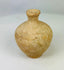 Roman terracotta juglet, 1st–3rd century CE, with rounded body, narrow neck, and flared rim, used for storing and pouring oils or perfumes, with natural aged patina.