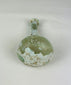 Base of Roman glass bottle with smooth circular finish and aged iridescent surface from antiquity.