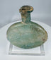 Ancient Roman cosmetic flask mounted on acrylic stand with authentic age-related weathering