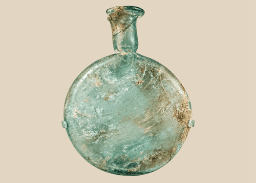 Ancient Roman pale green glass flask with flattened body and long neck displayed on acrylic stand