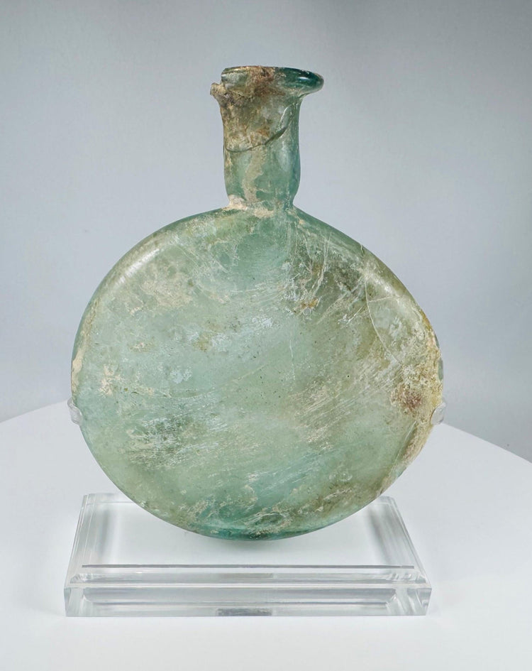 Roman free-blown glass perfume flask with iridescence and burial encrustation circa 1st–3rd century CE
