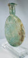 Roman Empire pale green glass vessel with burial weathering and elegant flattened profile