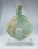 Roman archaeological glass flask showing iridescence, surface encrustation, and historic repairs