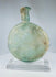 Antique Roman free-blown glass flask with mineral encrustation and translucent green coloration