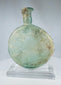 Antique Roman free-blown glass flask with mineral encrustation and translucent green coloration