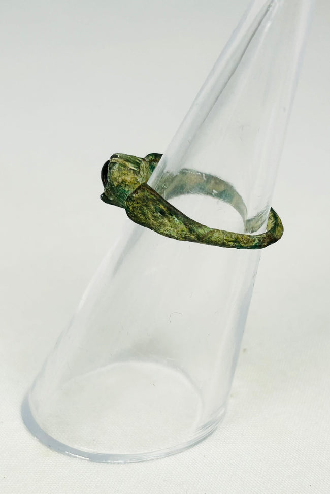 Archaeological Roman jewelry artifact displayed on museum-style black presentation stand