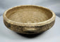 Interior view of an ancient Roman terracotta bowl highlighting the raised central boss and surviving white slip.