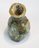 Archaeological green glass bottle with thick neck and mineralized surface patina