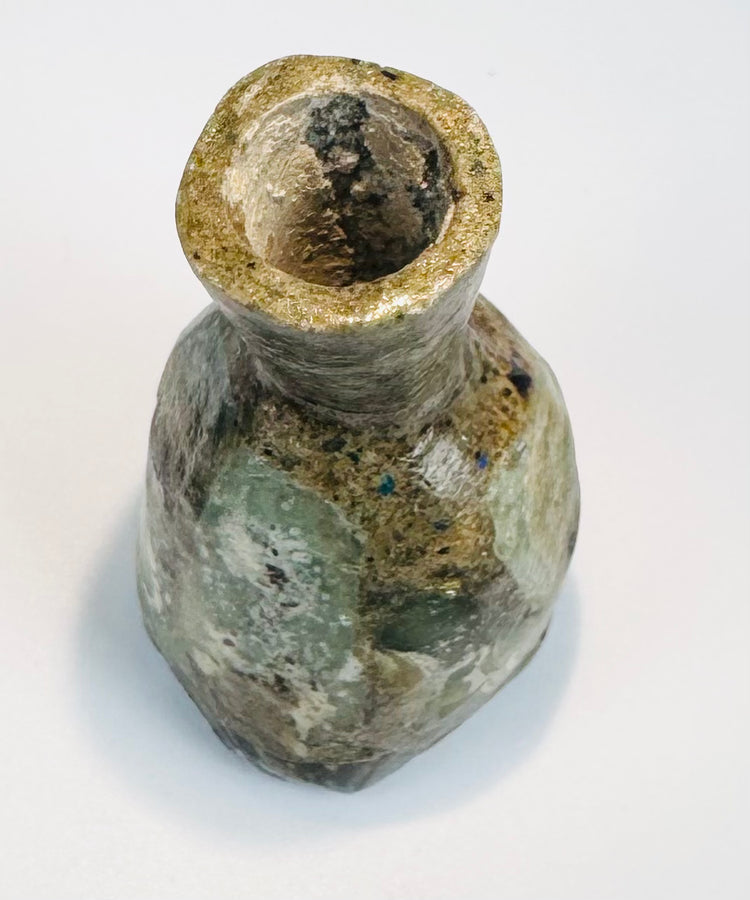 Archaeological green glass bottle with thick neck and mineralized surface patina