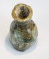 Archaeological green glass bottle with thick neck and mineralized surface patina