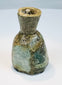 Ancient Roman unguentarium with compact body, narrow opening, and flattened base